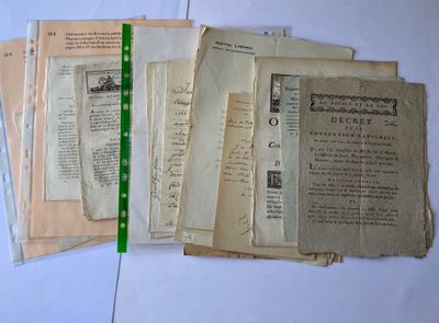 several old papers are stacked on top of each other on a table