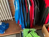 many different colored jackets hanging on a rack in a store
