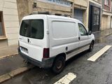 a white van that is parked on the side of the street