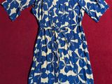 blue and white floral dress on a red surface