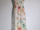 a dress on a mannequin stand against a white wall
