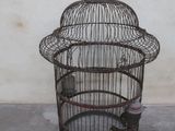 a bird cage with a bird inside of it