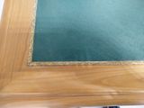 a wooden table with a green cloth on top of it