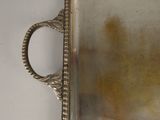 a silver tray that has a handle on it