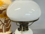 a lamp that is sitting on a table next to a vase