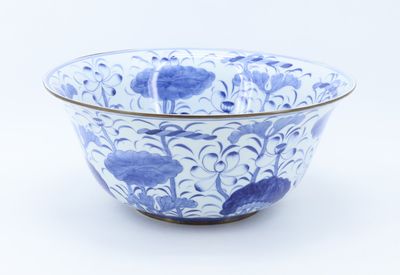a blue and white bowl sitting on a white surface