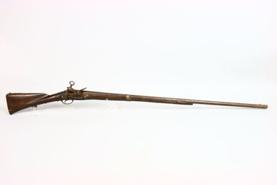 an old rifle with a wooden barrel and a wooden handle
