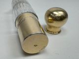 a gold object next to a silver object on a white surface