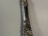 a silver spoon with a silver handle on a table