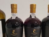 three bottles of wine are lined up on a table