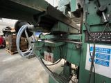 an image of a machine that is working on a piece of metal