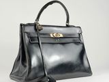 a black leather handbag on a white background