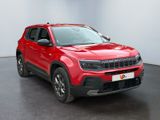 the red jeep compass suv is parked in a white room