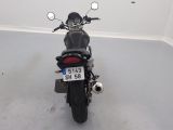 a motorcycle parked in a room with a number plate on it