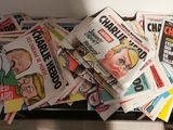 a pile of newspapers sitting on top of a table