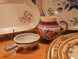 many plates and bowls sitting on a table