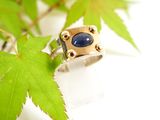a picture of a ring with a blue stone on it