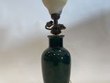an image of a green vase with a lamp on it