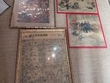 three framed pictures on the floor of a living room