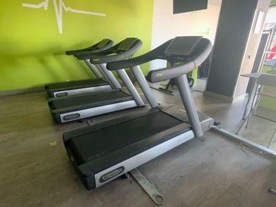 Plusieurs steppers sont alignés les uns à côté des autres dans une salle de sport