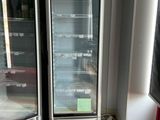 two refrigerators that are sitting in the corner of a room