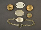 several different types of brass and silver bracelets on a black surface
