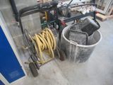 a picture of a bucket and a hose in a garage