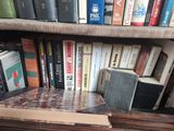 many books that are on a shelf in a book case