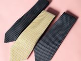 three ties on a pink background