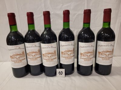 six bottles of wine are lined up on a table