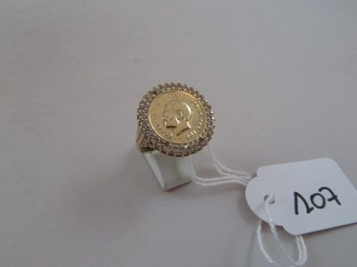a gold ring with a coin on it and a price tag
