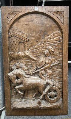 plaque en bois sculptée représentant un homme à cheval tirant une charrette sur laquelle se trouve un autre homme