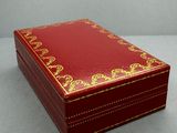 a small red box with a gold design on it