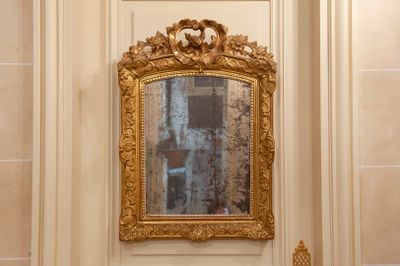 a mirror on the wall above a sink in a bathroom