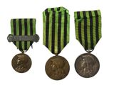 three medals and a medal on a white background