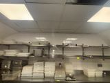 a large kitchen with a lot of dishes on the counter