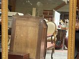 a large mirror sitting on the floor in a room