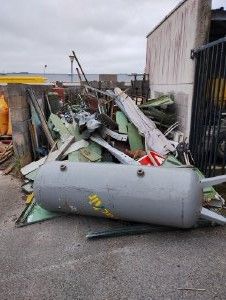 a pile of junk on the ground next to a building