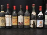 several bottles of wine are lined up in a row on a table