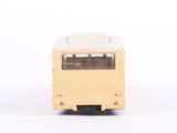 a yellow bus that is sitting on a white surface