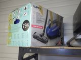 a box that is sitting on a shelf with a vacuum