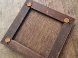a picture of a wooden picture frame on the floor