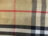 a close up of a plaid fabric with a red and black stripe