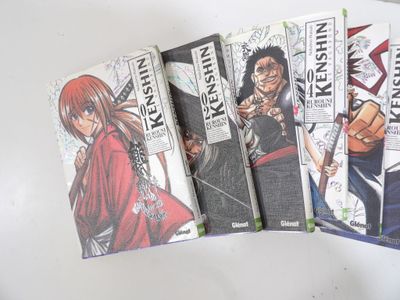 six books of anime comics are lined up on a table