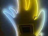 a neon sign that is on the ceiling of a building