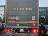 two trucks that are parked next to each other in a parking lot
