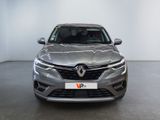 the front view of a silver car in a showroom