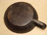 an old cast iron frying pan sitting on top of a wooden table
