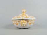a close up of a white and gold bowl with a lid