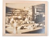an old photo of a woman in a dress shop